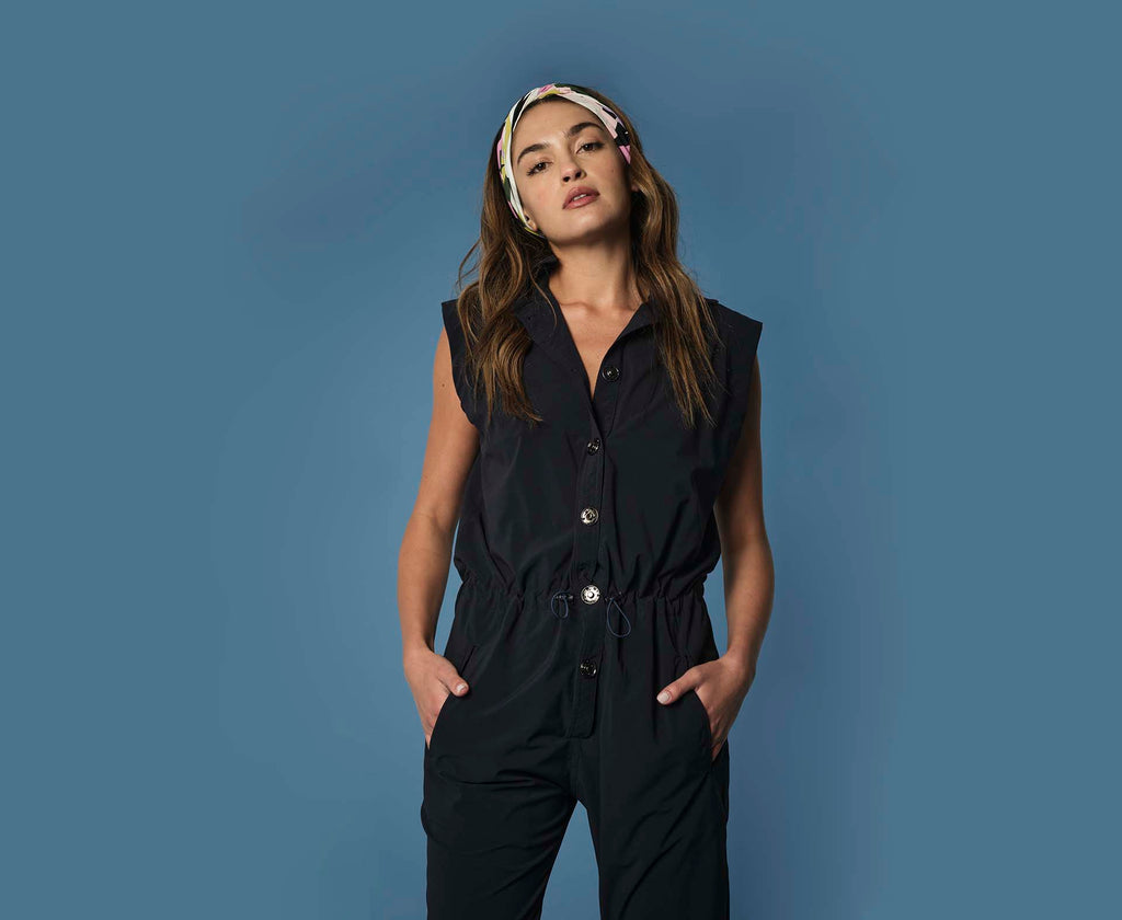 Woman wearing 925fit designer jumpsuit.
