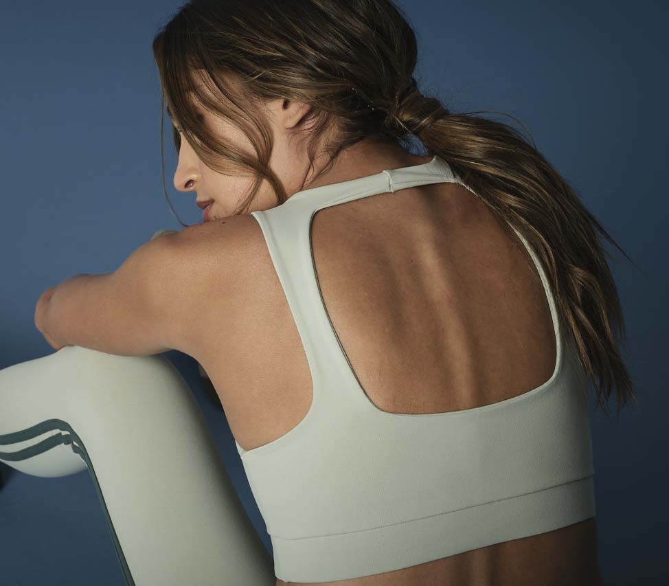 Woman is wearing 925 fit designer sports bra Fair and Square Pistachio.