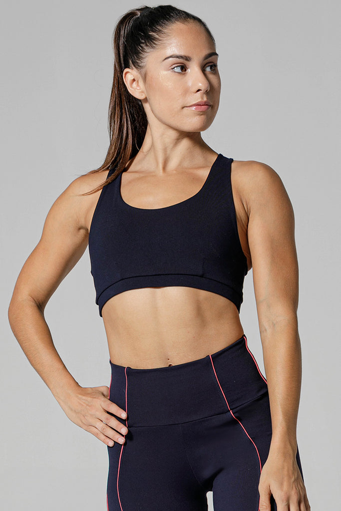 Woman is wearing 925 fit Sneak Peak Navy Sports Bra.