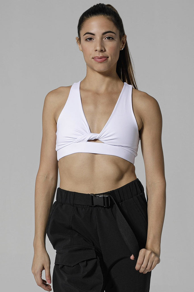 Woman is wearing 925 fit With a Twist White Racerback Sports Bra.