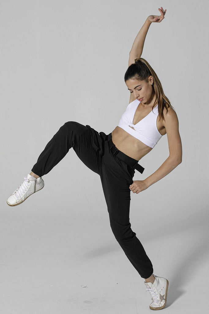 Woman is wearing 925 fit With a Twist White Racerback Sports Bra.