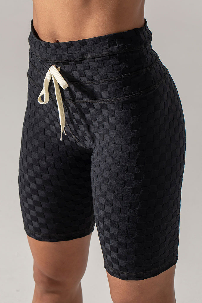 Woman wearing 925 fit Fair Square Black Jacquard athletic shorts.