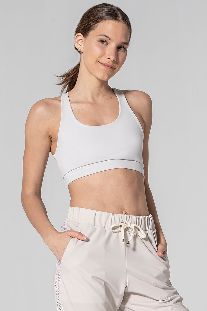 Woman is wearing 925 fit Get In Line Ash Racerback Sports Bra.