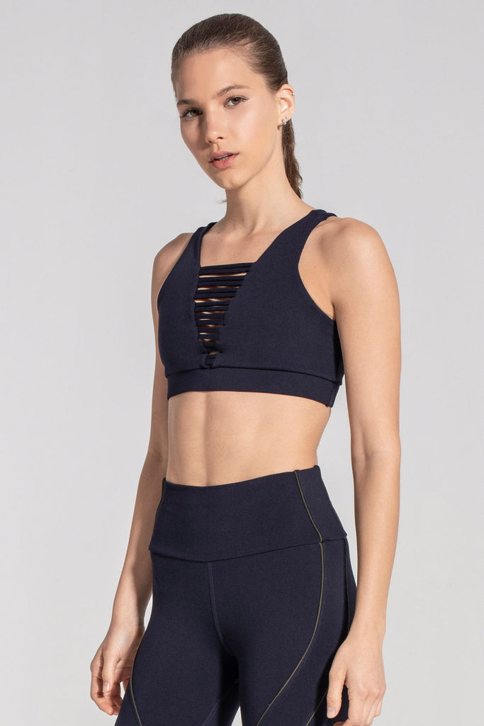 Woman is wearing 925 fit No Strings Attached Navy Sports Bra.