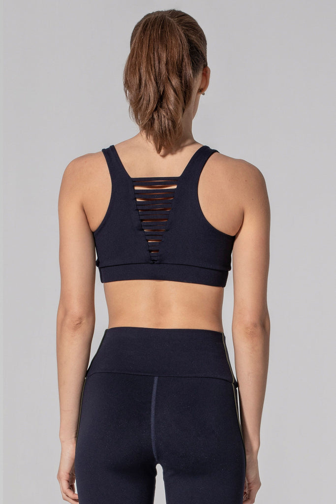 Woman is wearing 925 fit No Strings Attached Navy Sports Bra.