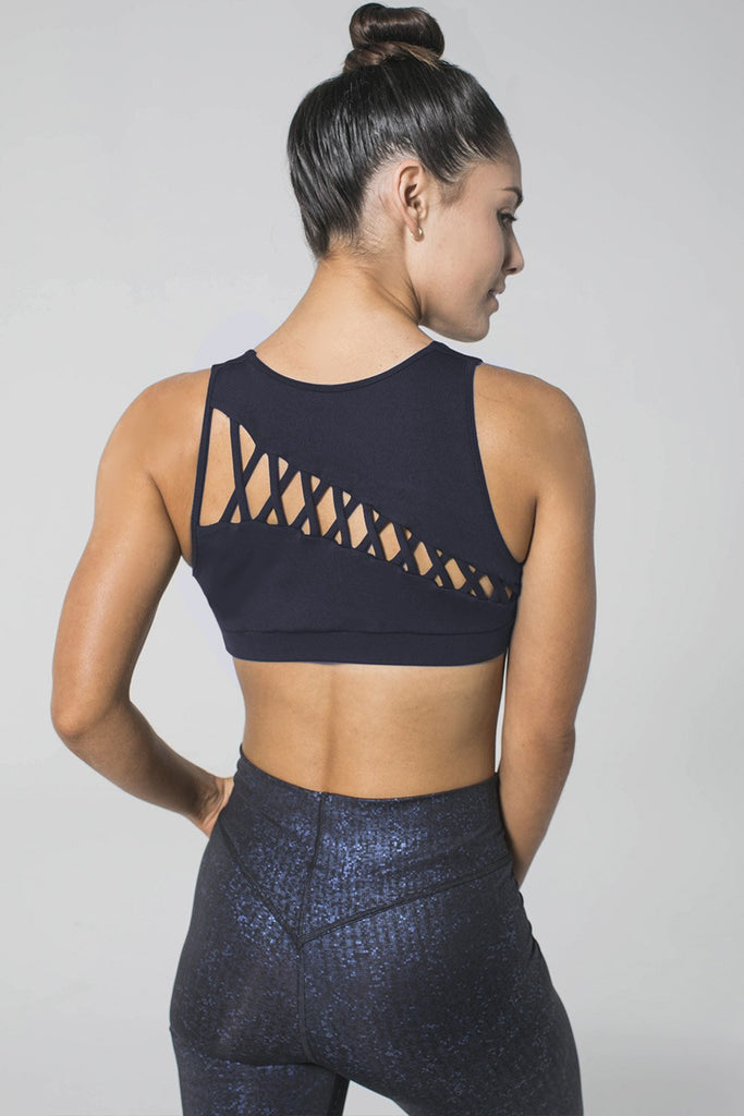 Woman is wearing 925 fit navy sports bra and navy yoga pants
