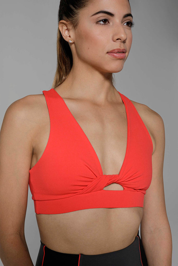 Woman is wearing 925 fit With a Twist Scarlet Sports Bra.