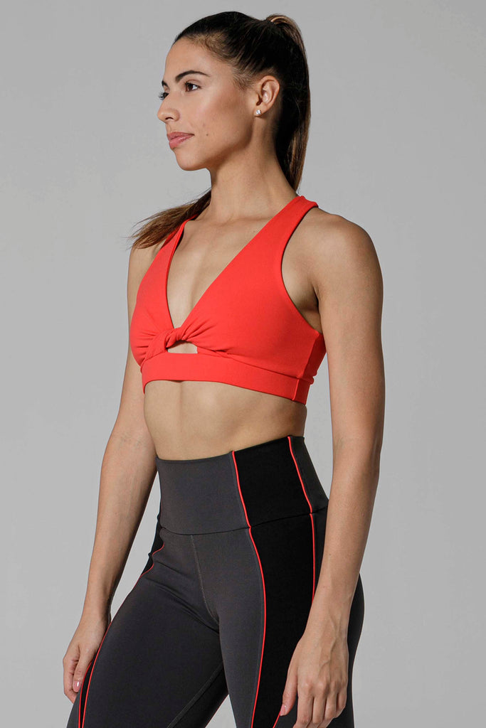 Woman is wearing 925 fit With a Twist Scarlet Sports Bra.