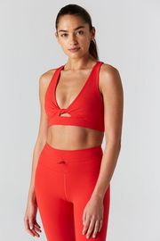 Woman is wearing 925 fit With a Twist Scarlet Sports Bra.