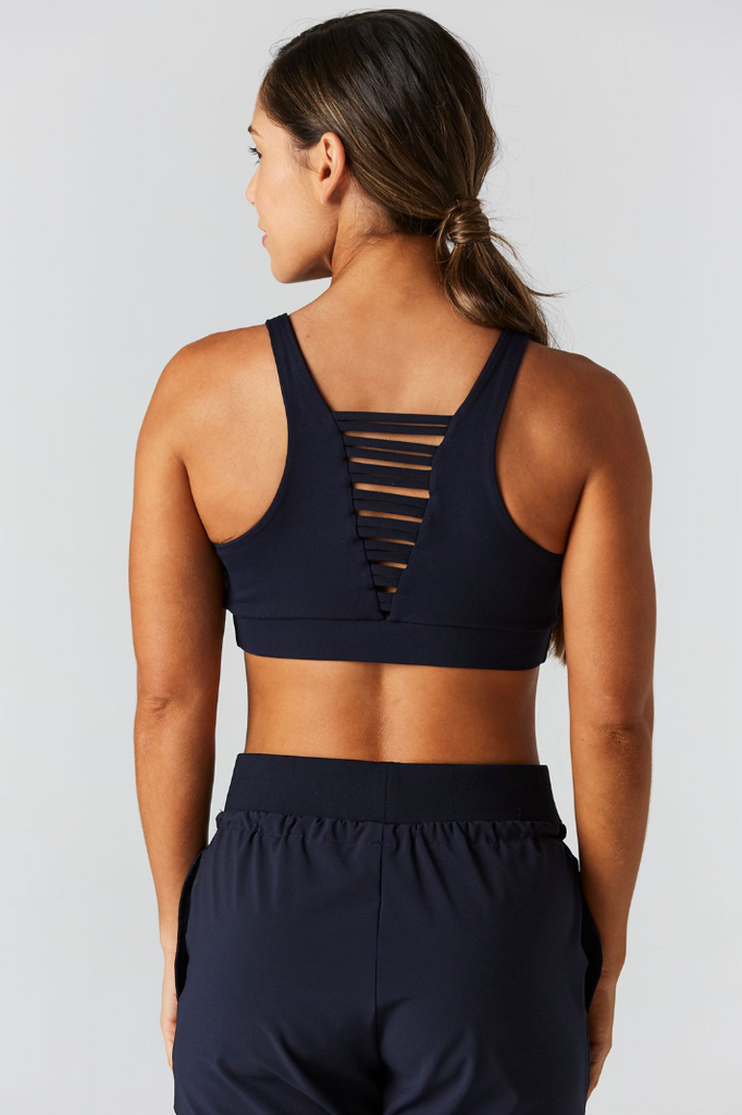 Woman is wearing 925 fit No Strings Attached Navy Sports Bra.