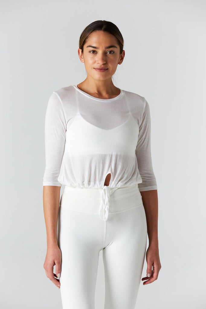 Woman is wearing 9 2 5 fit T42 White Crop Tee