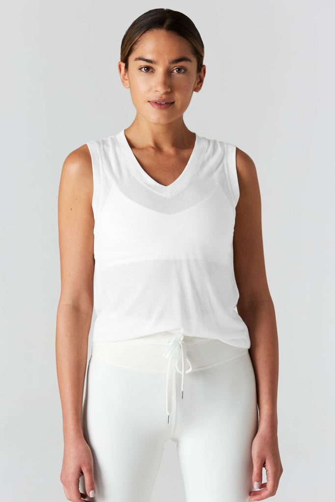 Woman is wearing 9 2 5 fit The Vine White Muscle Tee