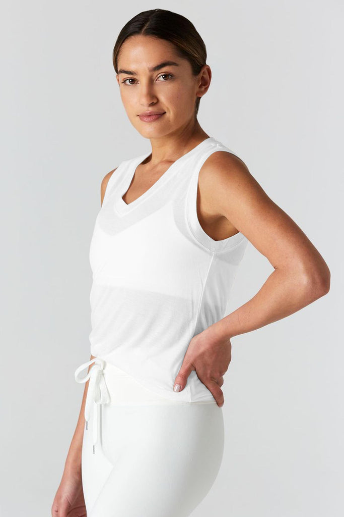 Woman is wearing 9 2 5 fit The Vine White Muscle Tee