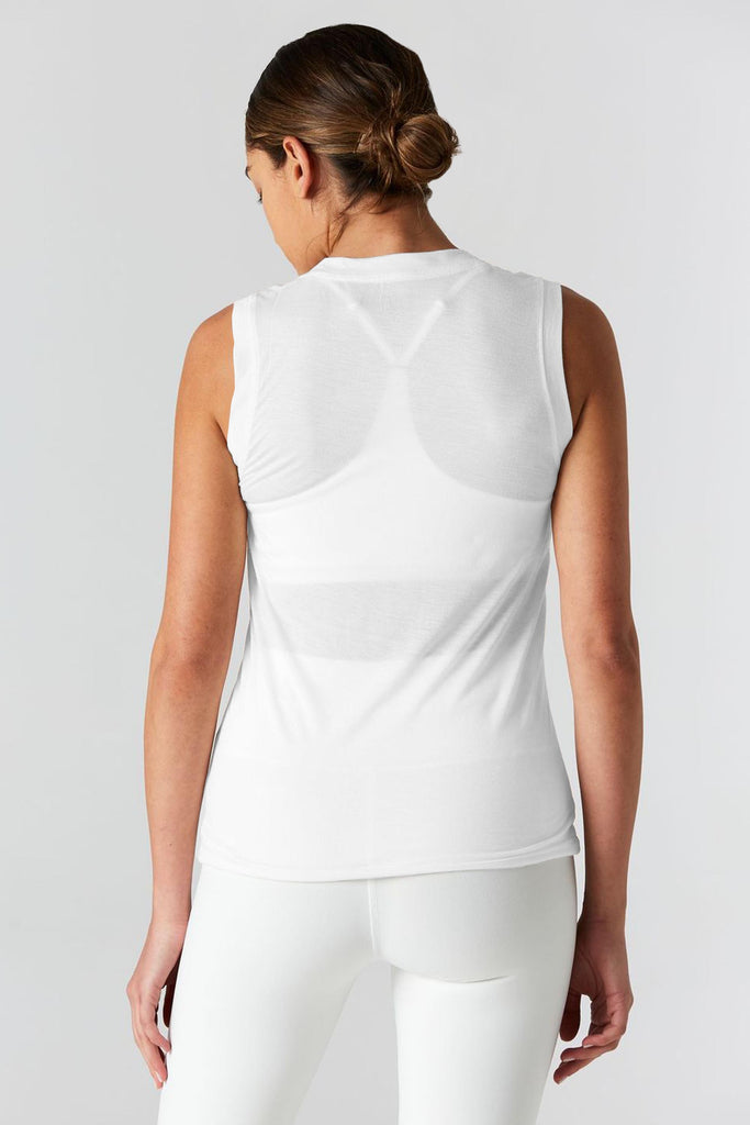 Woman is wearing 9 2 5 fit The Vine White Muscle Tee