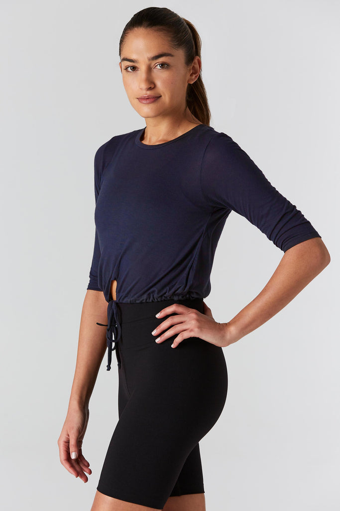 Woman is wearing 9 2 5 fit T42 Navy Crop Tee