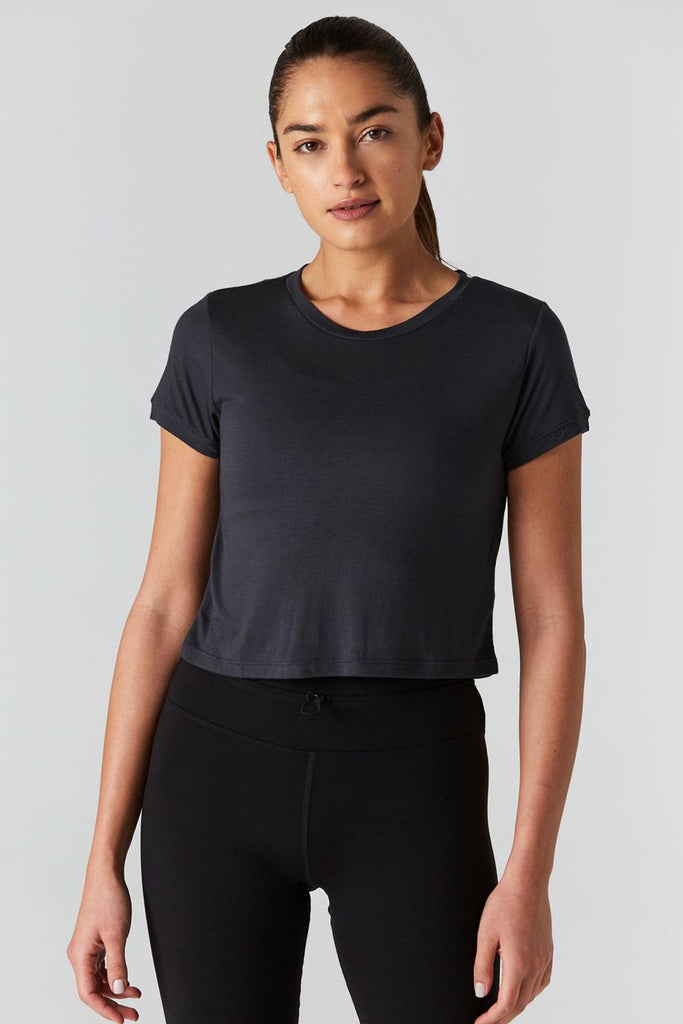 Woman is wearing 9 2 5 fit Cut the Crop Slate Crop Tee