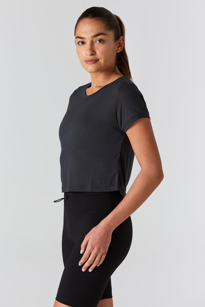 Woman is wearing 9 2 5 fit Cut the Crop Slate Crop Tee