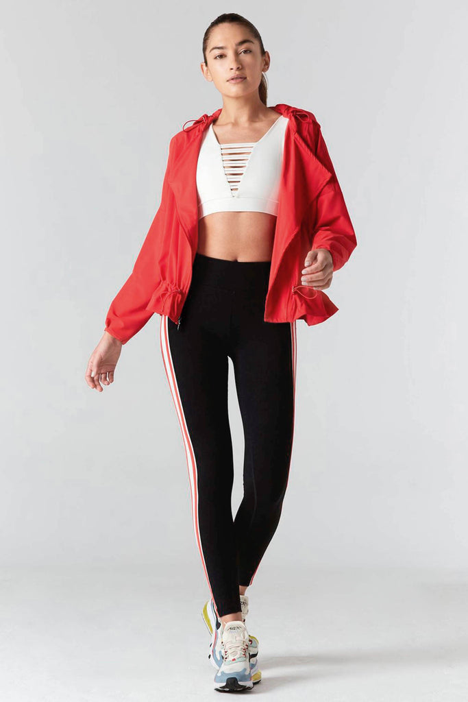 Woman is wearing 925 fit cream sports bra and black yoga pants