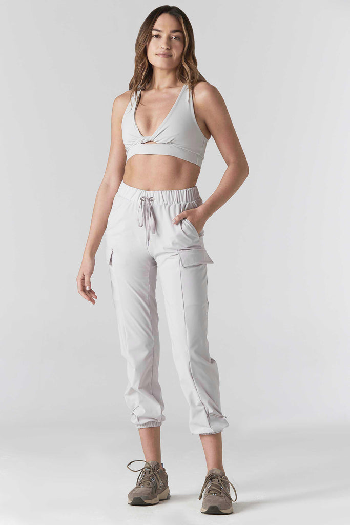 Woman is wearing 925 fit With a Twist Ash Racerback Sports Bra.