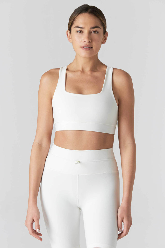 Woman is wearing 925 fit Fair & Square Cream Sports Bra.