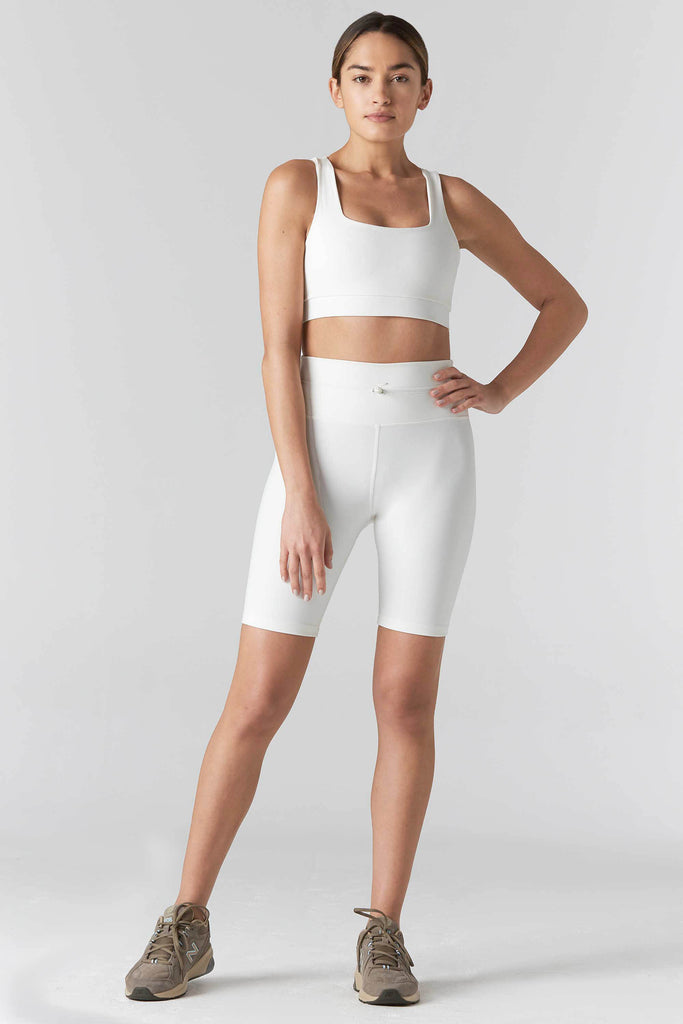 Woman is wearing 925 fit Fair & Square Cream Sports Bra.