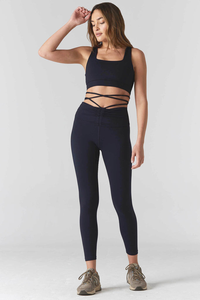 Woman is wearing 925 fit Fair & Square Navy Sports Bra.