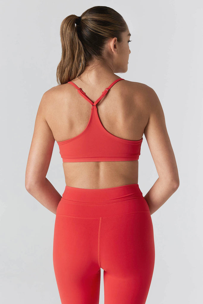 Woman is wearing 925 fit In House scarlet Sports Bra.