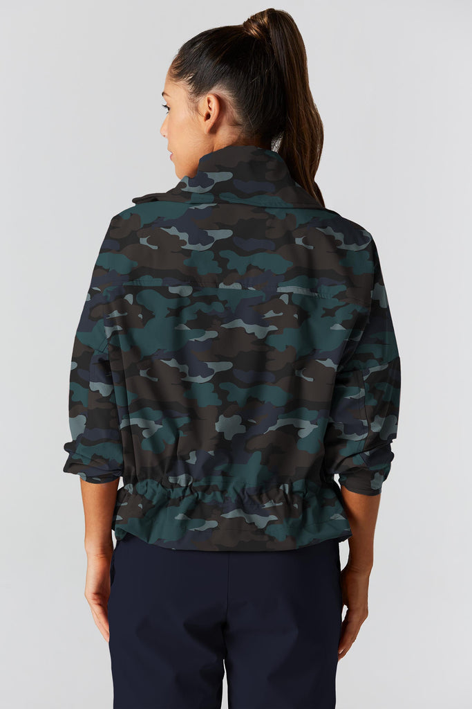 Woman is wearing 925 fit D-side camo basil jacket.